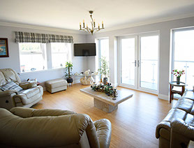 Stay in a comfortable guest living room at Heatherfield House Bed and Breakfast Accommodation near Portree